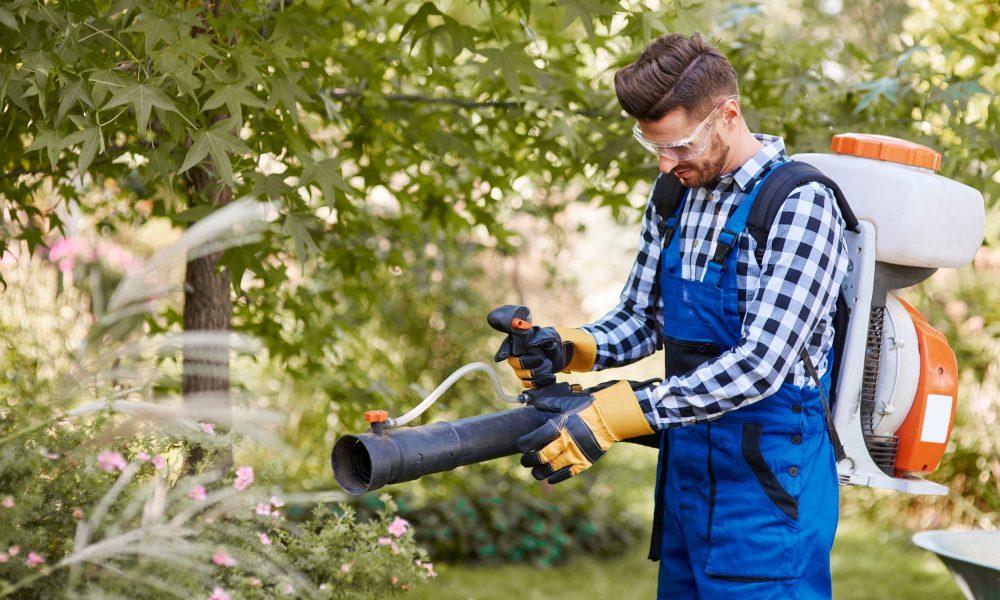 Gardener using modern gardening equipment