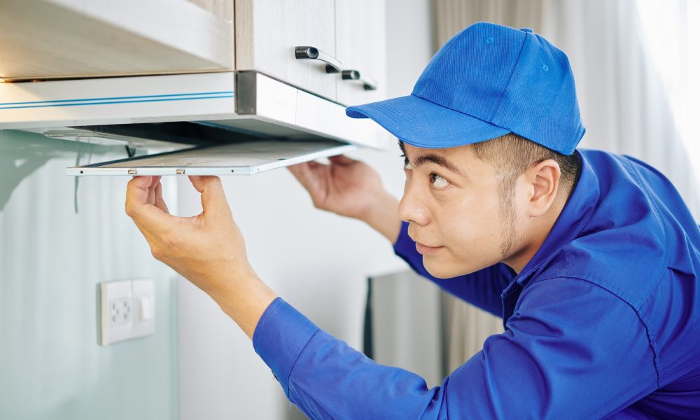 Handyman installing cooker hood