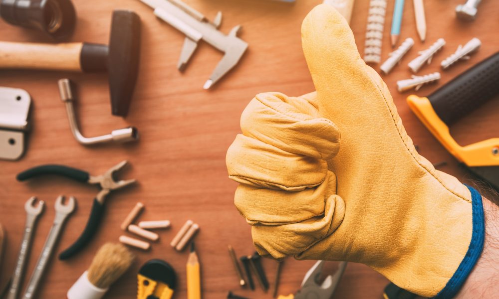 Maintenance handyman gesturing thumb up approval hand sign, top