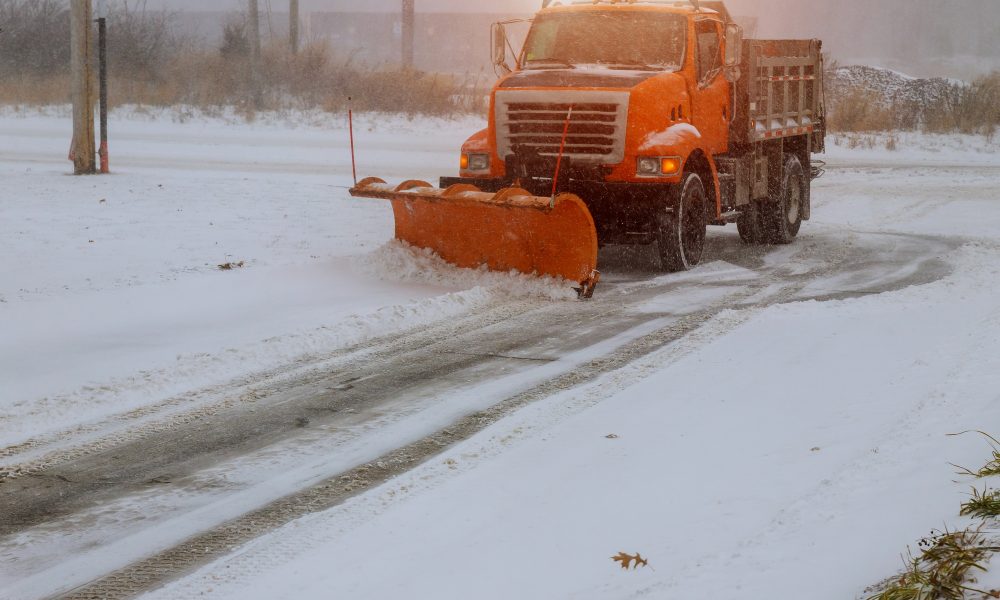 Tractor on the removal snow with snow machines on heavy snowfall.